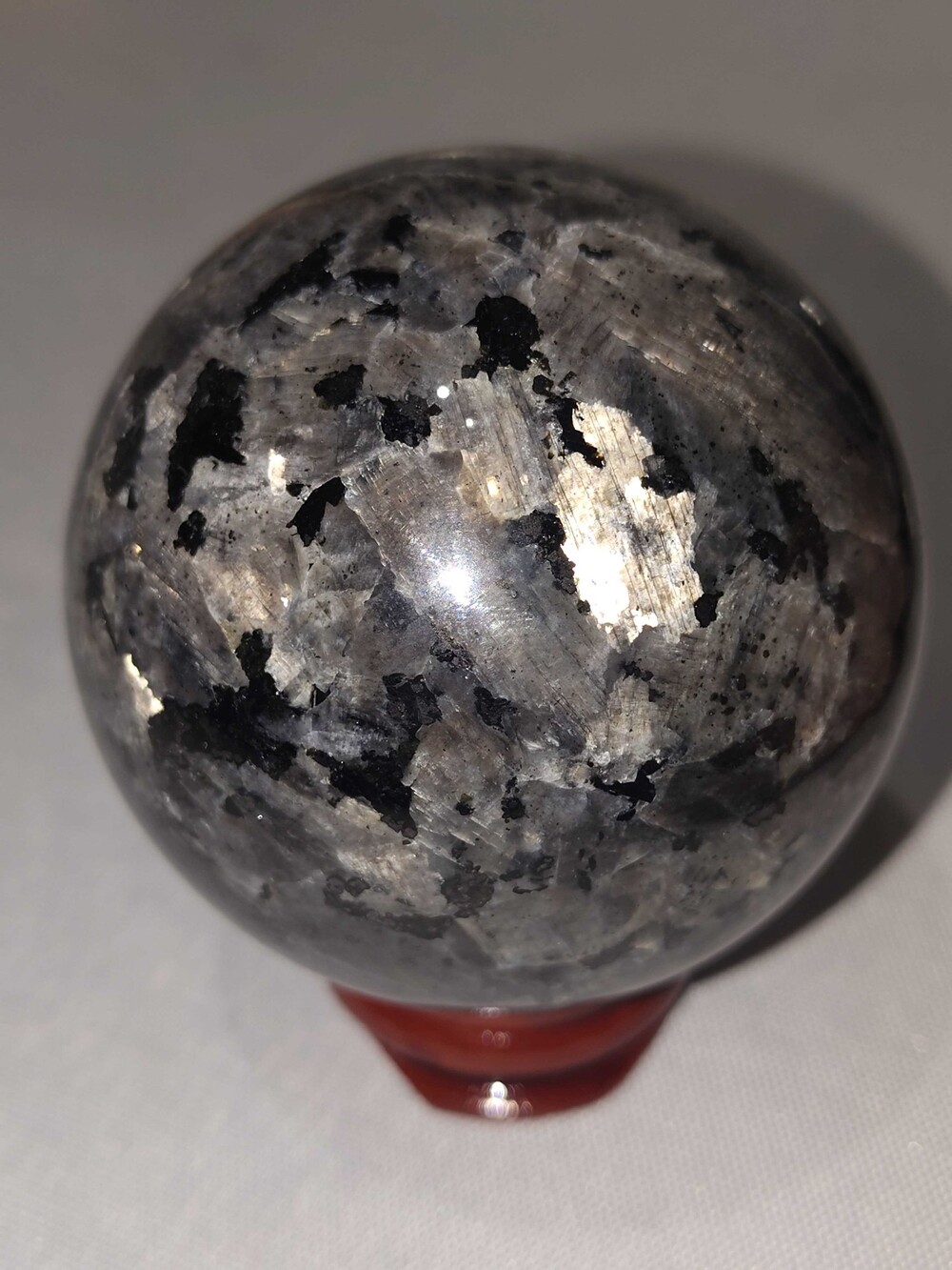 Larvakite Polished Sphere Black Silver Crystal with Reddish-Brown Stand